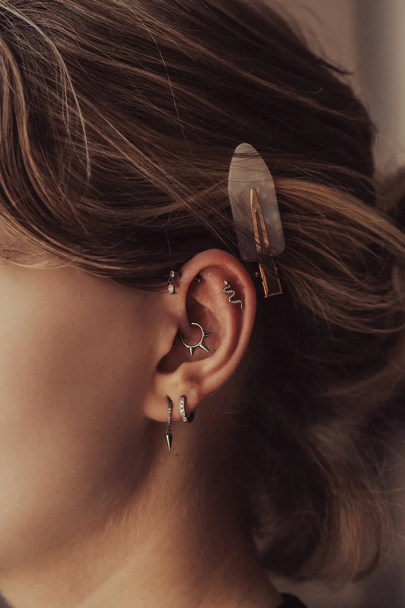 Completed ear curation with various piercings and jewelry